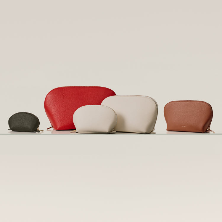 Five zipper pouches in different sizes and shapes displayed on a surface.