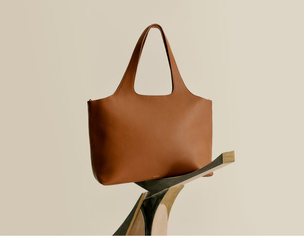 Handbag resting on a diagonal support.