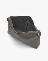 Open cosmetic bag on a plain background.