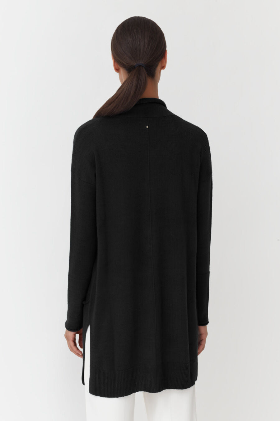 Person from behind, standing straight, hands not visible.