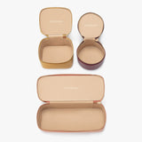 Four open jewelry cases displayed from above.