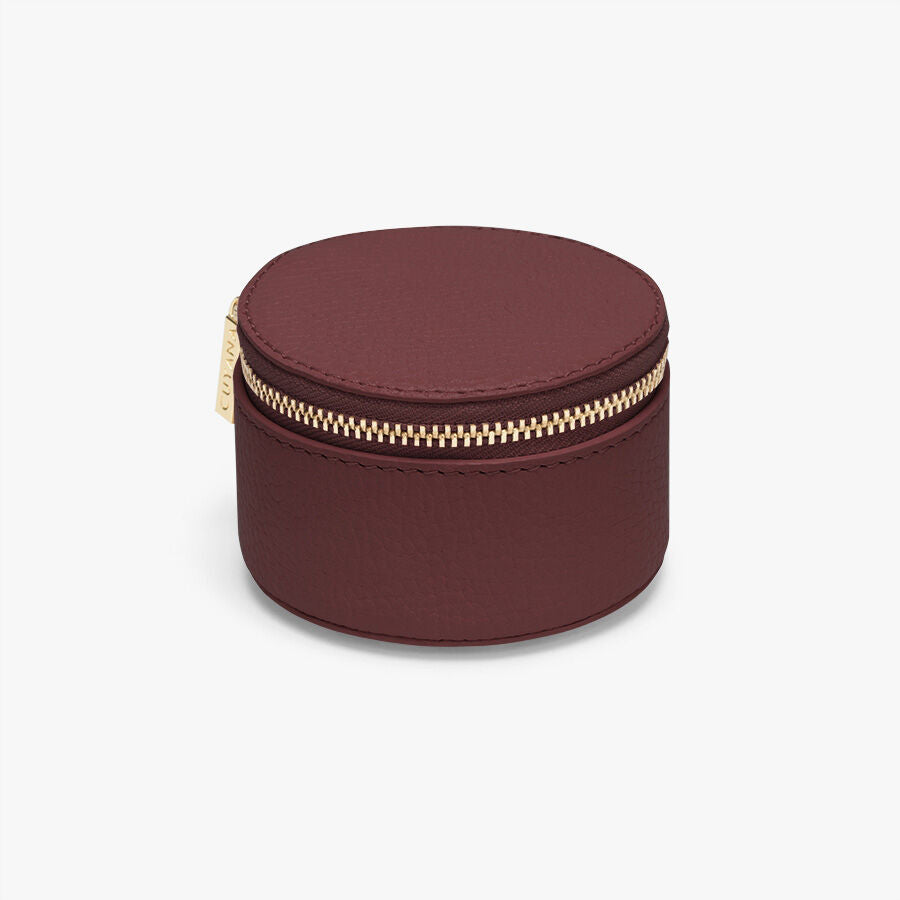 Small round jewelry box with a zipper closure