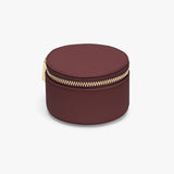 Small round jewelry box with a zipper closure