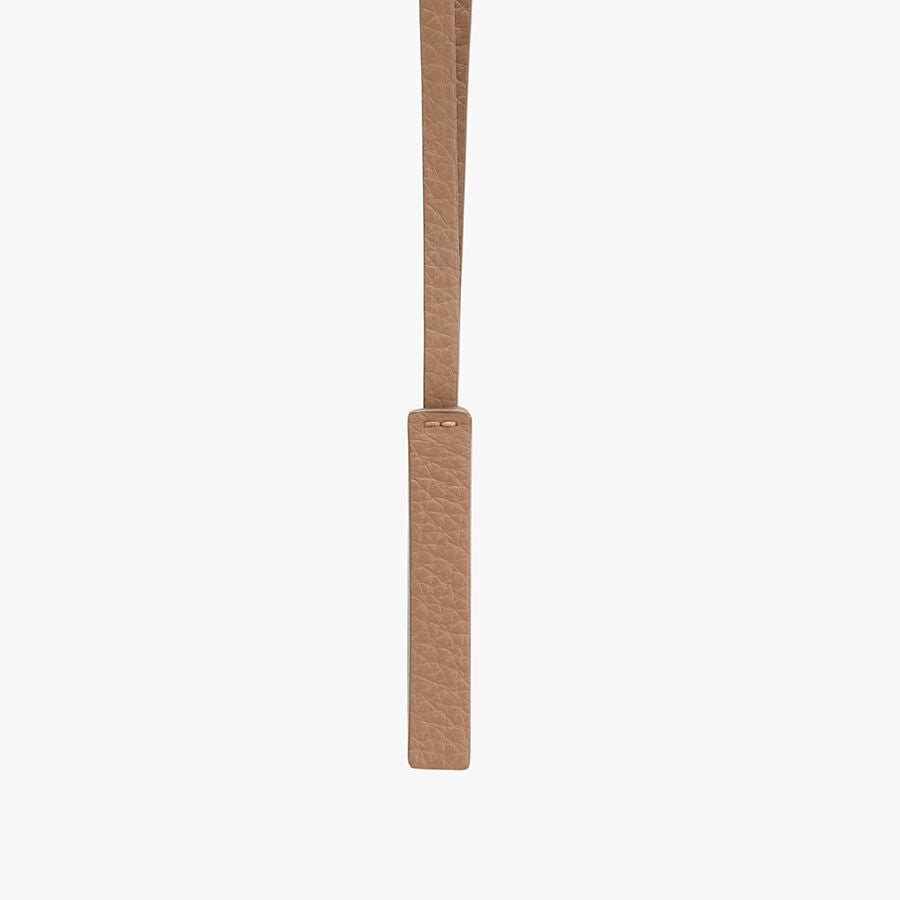 Leather strap hanging vertically with a loop at the top.